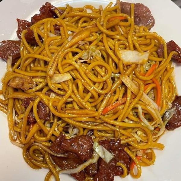 Bao Bao Chinese Bistro's beef lo mein with noodles, beef, cabbage, and carrots on a white plate.