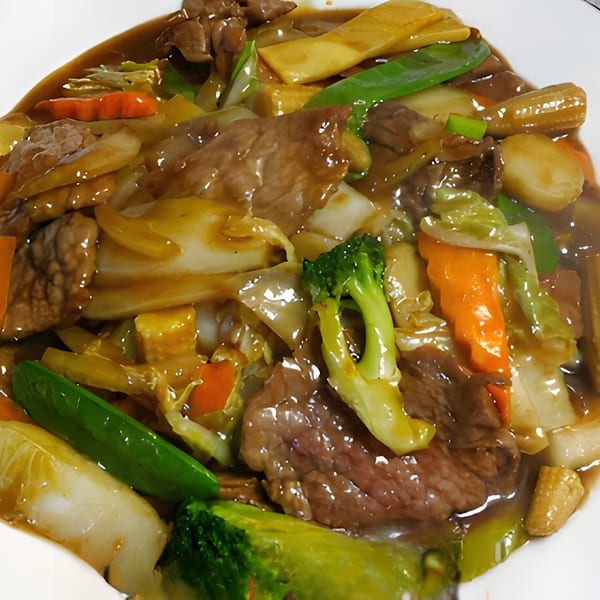 Close-up of Chinese beef and mixed vegetables in a rich brown sauce.
